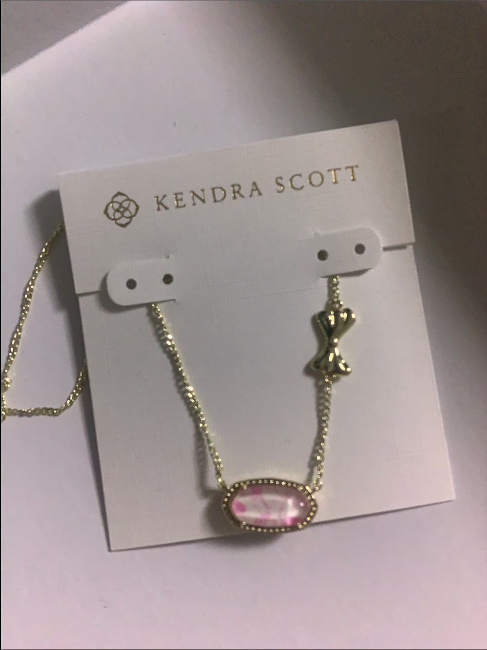 Kendra Scott Gold Necklace with Pink Oval Pendant and Decorative Charm
